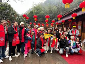 a group of people posing for a picture in front of a temple at Home Away from Home in Zhangjiajie
