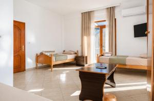 a living room with a room with two beds and a table at Bar Hotel Tirana in Kukës