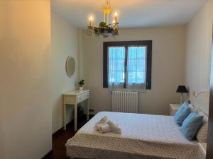 a bedroom with a bed with a stuffed animal on it at Balentzenea Rural House in Lesaka
