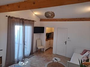 a living room with a couch and a chair at BEAU STUDIO NEUF en provence in Pélissanne