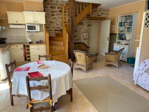 a kitchen with a table and chairs in a room at Le Manoir de Gourvinec in Saint-Nolff