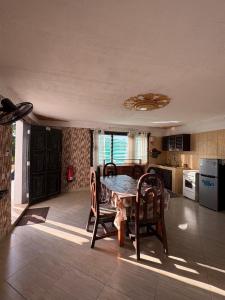 a kitchen with a table and chairs in a room at Villa Tuffah in Watamu