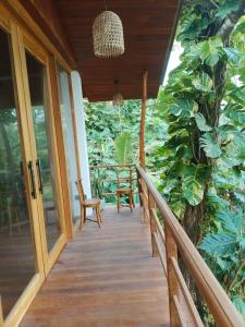 a porch of a house with a table and chairs at Mukalawatta Villa in Matara