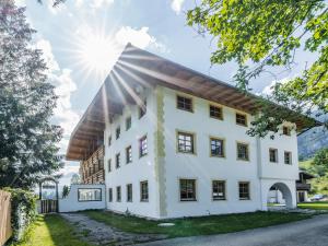 a large white building with the sun in the background at Chalet in Angerberg near SkiWelt Slopes in Angerberg