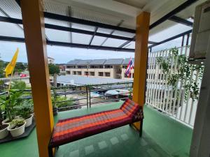 a bench sitting on top of a balcony at DK1Hostel in Chaweng