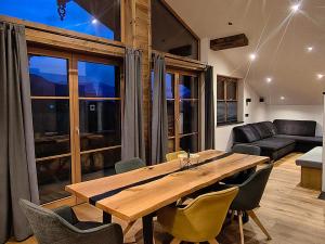 a dining room with a wooden table and chairs at biohof Stiedler in Sankt Johann in Tirol