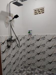 a lamp in a room with a white wall at Bajo Komodo Homestay in Komodo +182 photos