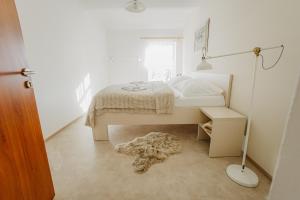 a bedroom with a bed and a lamp and a rug at Penzion Albertovec in Opava