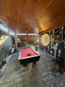 a man and a child playing with a pool table at Sixtor hause in Salonta