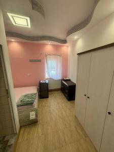 a bedroom with a bed and a cabinet and a window at Sixtor hause in Salonta