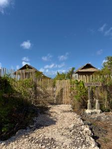 a wooden fence with a sign in front of it at Kampa Lodge in Tano
