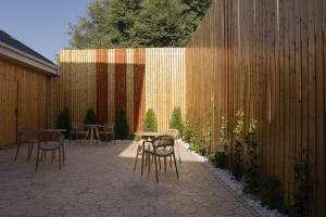 a patio with chairs and a table and a fence at Solara in Bishkek