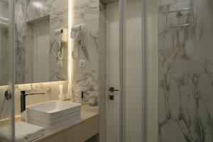 a bathroom with a sink and a shower at Solara in Bishkek +79 photos