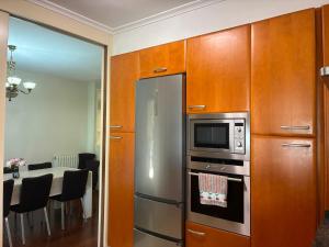 a kitchen with a stainless steel refrigerator and a table at Balentzenea Rural House in Lesaka