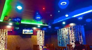a room with blue and green lights and chairs at Pine View Resort in Gulmarg