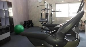 a gym with a treadmill and a green ball at Mayor Hotel in Siliguri