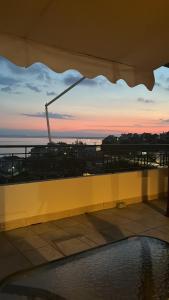 a view of the sunset from the balcony of a building at Panorama in Menídion