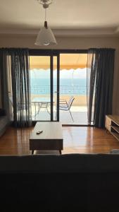 a living room with a view of the beach at Panorama in Menídion