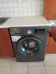 a washing machine in a kitchen with a counter at Panorama in Menídion