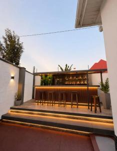 a patio with benches and tables in front of a building at The Serenity Hideaway in Arusha