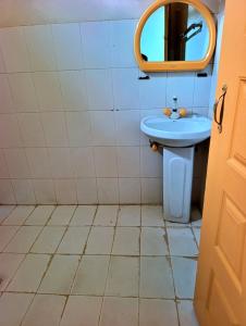 a bathroom with a blue sink and a mirror at Eden Plus Executive Hotel Lahore in Lahore