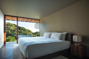 a bedroom with a large bed and a large window at WEAZER 西伊豆 in Izu +55 photos