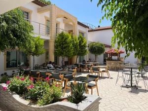 a patio with tables and chairs in a courtyard at Nagas Premium Hotel in Yenişehir
