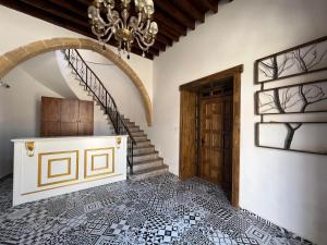 a bedroom with a staircase and a chandelier at Nagas Premium Hotel in Yenişehir
