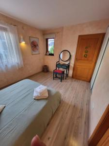 a bedroom with a bed and a chair and a door at Vignoble in Bennwihr