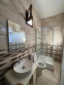 a bathroom with a sink and a toilet and a shower at Nagas Premium Hotel in Yenişehir +195 photos