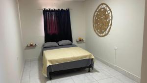 a bedroom with a bed with a black curtain at Pousada Horizontes de Bonito Apto in Bonito