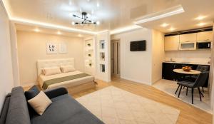 a living room with a couch and a bed at Габдуллина 79 in Kokshetau