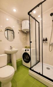 a bathroom with a toilet a sink and a washing machine at Габдуллина 79 in Kokshetau