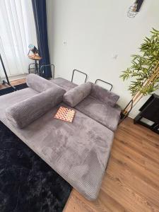 a large couch sitting in a living room at Chill & Play in Casteljaloux