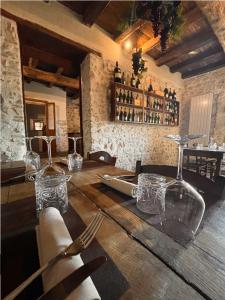 a wooden table with glasses and utensils on it at La chiave del Tempo in Casteldilago