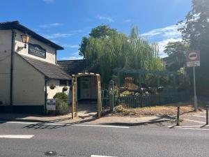 a building with a gate in front of a house at Stopover Stoford in Stoford