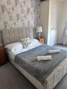 a bedroom with a large bed with two pillows on it at Stopover Stoford in Stoford +10 photos