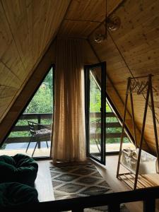 a room with a large window in a house at Gerlik Cottage in Mestia