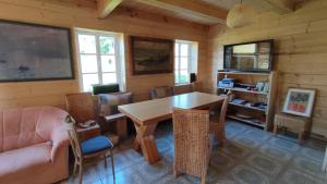 a dining room with a wooden table and chairs at Roubenka in Nieder Kreibitz +10 photos
