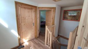 a hallway with a door and stairs in a house at Roubenka in Nieder Kreibitz