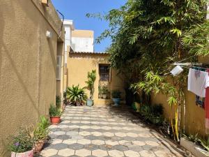 a courtyard of a house with plants at Malika Surf House in Dakar
