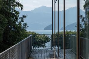 a room with a view of the water and mountains at Seminar-Hotel Rigi am See in Weggis