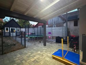 a screened in backyard with a trampoline at Apartmani LU&LO in Delnice