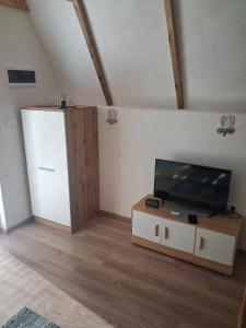 a living room with a tv and a cabinet at Lajlas home in Orašac