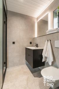 a bathroom with a sink and a mirror at Black Grouse Lodge in Tällberg +34 photos