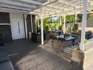 an outdoor patio with a white pergola at Haus Wijnen in Bad Bentheim