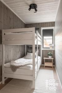 a white bunk bed in a room with a ceiling at Black Grouse Lodge in Tällberg