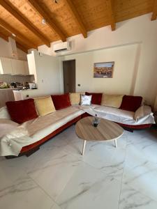 a living room with a couch and a table at Makis & Lena's Home in Svoronata