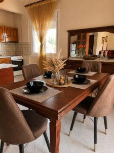 a wooden table in a kitchen with chairs around it at Philoxenia House in Sidirokastro
