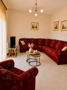 a living room with a red couch and a table at Philoxenia House in Sidirokastro